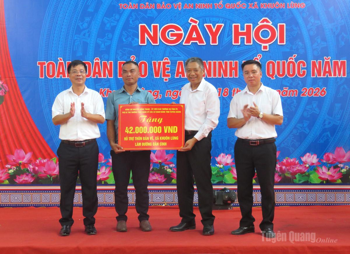 Đồng chí Nguyễn Hồng Trang, Phó Bí thư Thường trực Đảng ủy các cơ quan Đảng tỉnh, trao biểu trưng số tiền hỗ trợ thôn Bản Vẽ làm đường dân sinh.